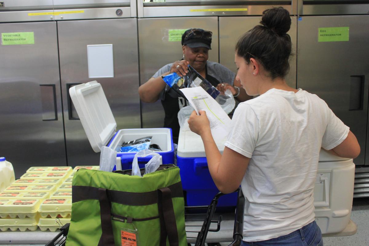 volunteers pack groceries for delivery