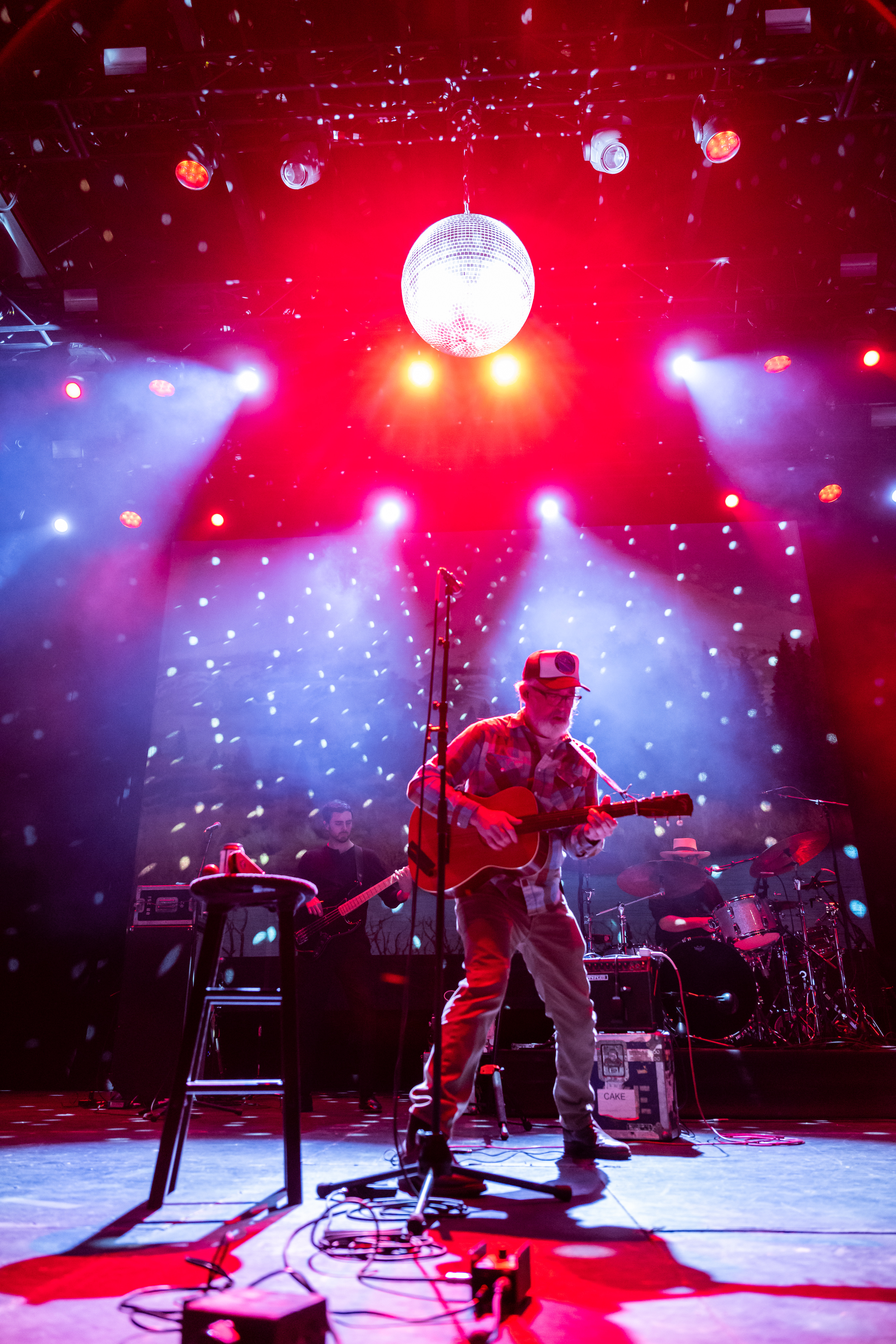 Red disco ball shining over performance