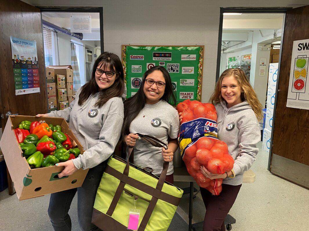 Volunteers holding boxes of food