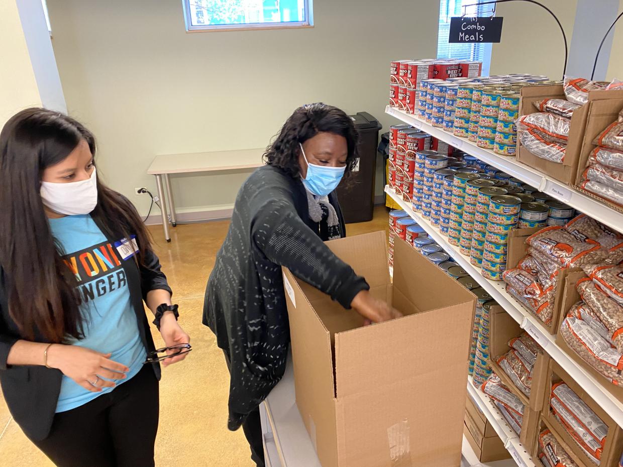 Alderman Emma Mitts packing a box for a Home Delivery Recipient