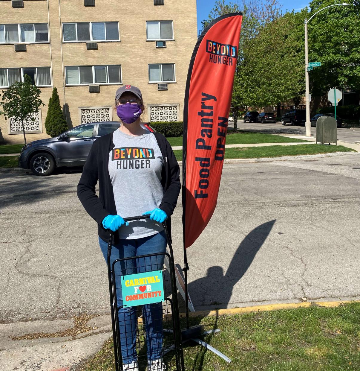 Carnival Cares - Shopping Cart and Katie Kearns near the Beyond Hunger flag