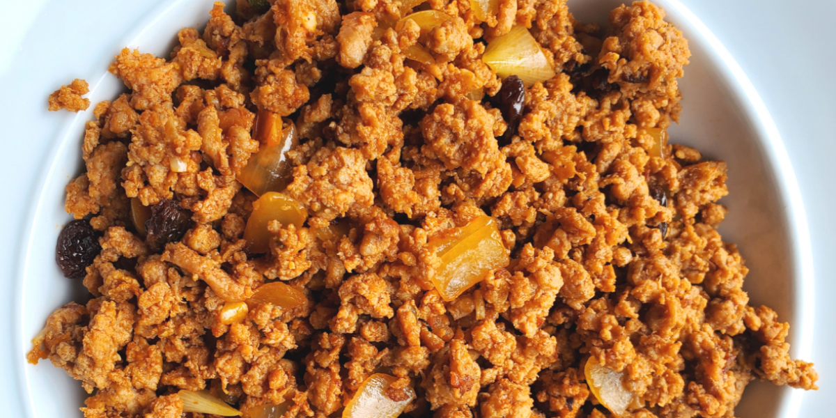 Beef Picadillo Recipe Photo. Image of beef picadillo on a white plate, with a white background.