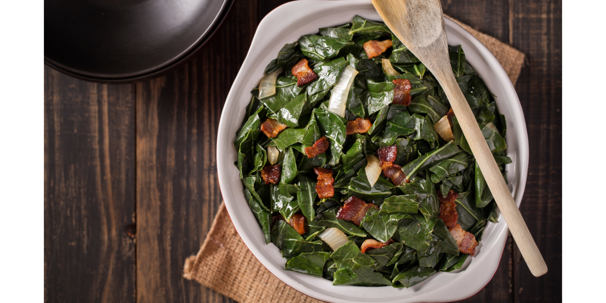 Braised greens in white bowl, with wooden spoon across the top of the dish.