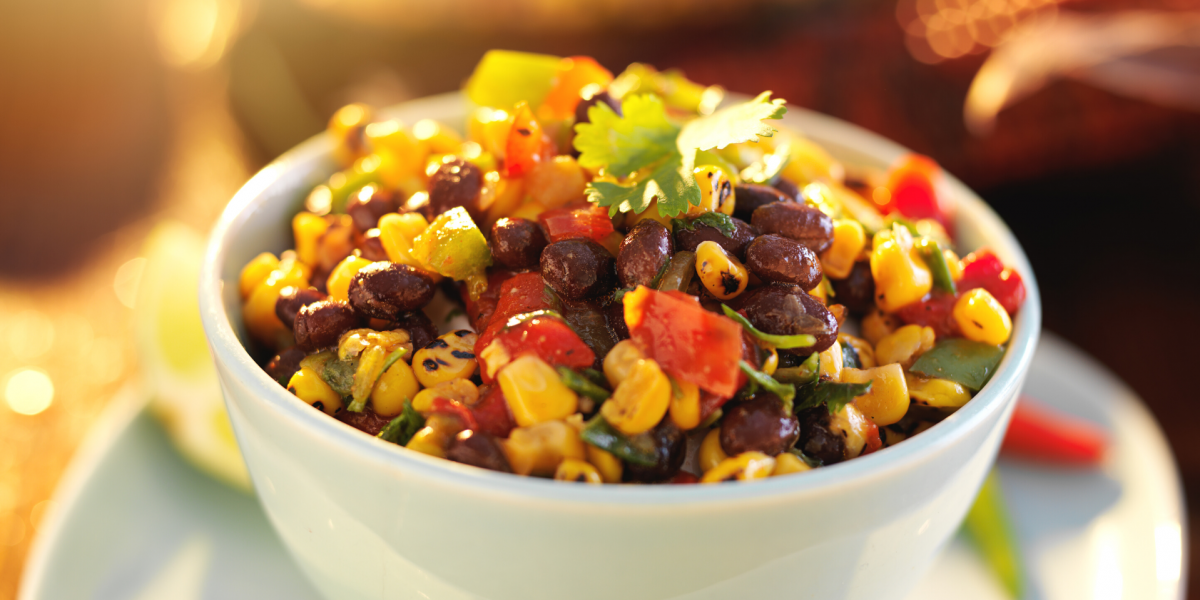 Charred Corn and Black Bean Salad Recipe Photo. A colorful bowl of food, in a white bowl.