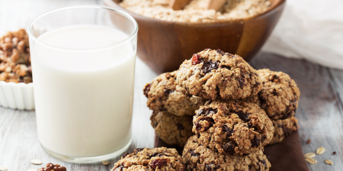 Oatmeal Raisin Cookie Baked Oatmeal Recipe Photo. Pile of cookies next to a glass of milk in a clear glass.