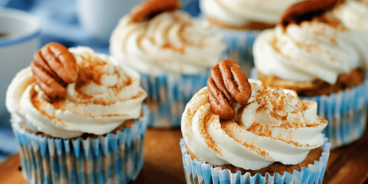 Hummingbird Cupcakes with cream cheese frosting - light dusting of cinnamon and pecan halves