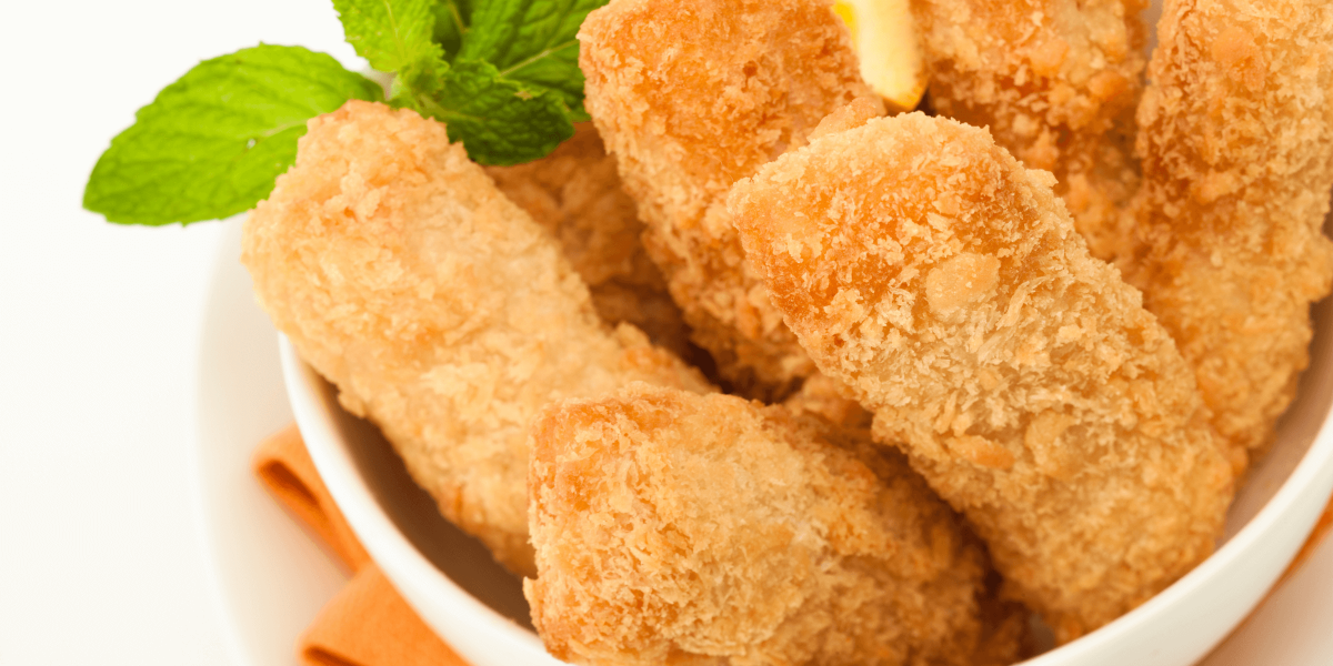 crispy catfish nuggets in a bowl with lemon wedge