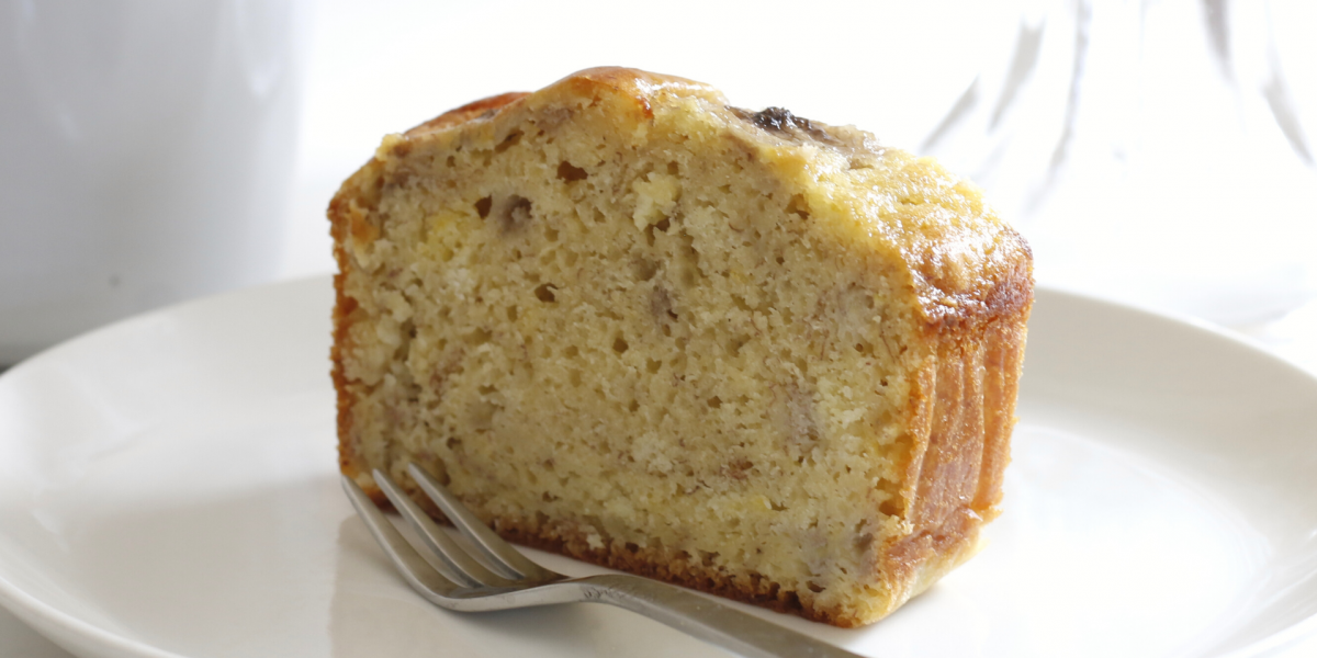 Thick slice of Yogurt Banana Bread on a white plate, against a white background.