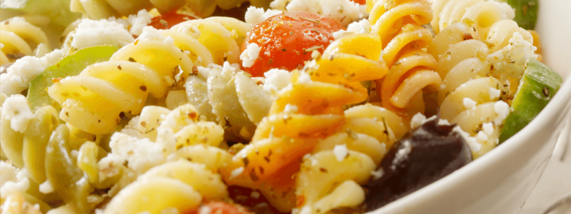 Spiral pasta with feta cheese and cucumbers and tomatoes