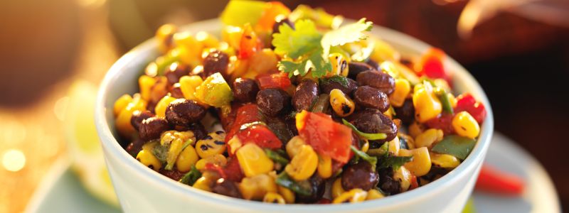 Charred Corn and Black Bean Salad Recipe Photo. A colorful bowl of food, in a white bowl.