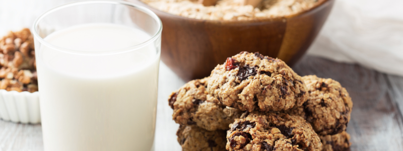 Oatmeal Raisin Cookie Baked Oatmeal Recipe Photo. Pile of cookies next to a glass of milk in a clear glass.