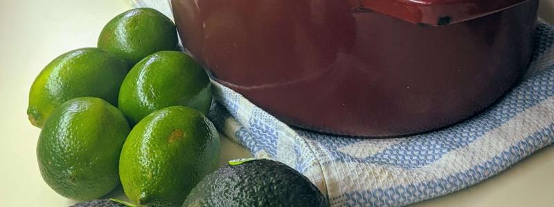 Slow Roasted Pork Loin in dutch oven with lime and avocado in front of the picture