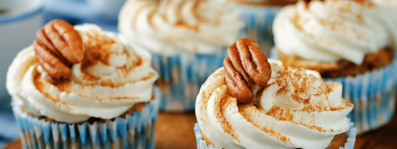 Hummingbird Cupcakes with cream cheese frosting - light dusting of cinnamon and pecan halves