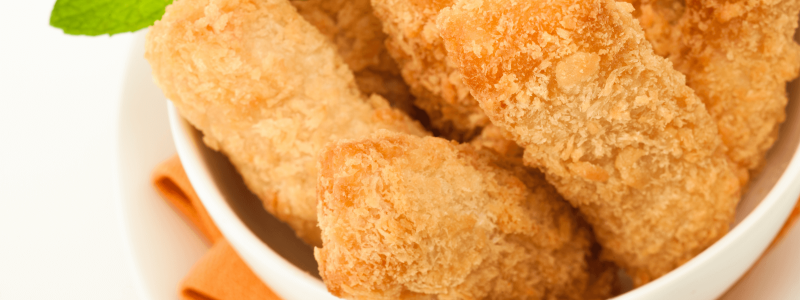crispy catfish nuggets in a bowl with lemon wedge