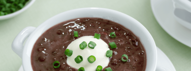 photo of back bean soup, sour cream