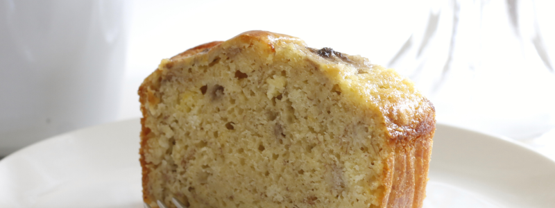 Thick slice of Yogurt Banana Bread on a white plate, against a white background.