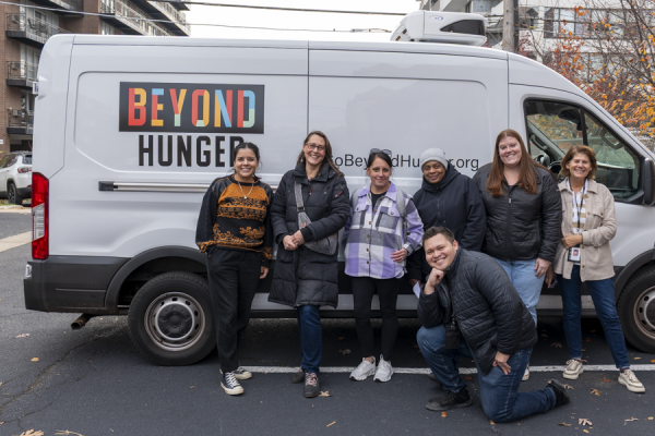 Beyond Hunger staff and Hephzibah staff and volunteers posing in front of a Beyond Hunger van