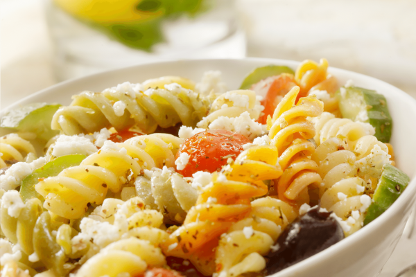Spiral pasta with feta cheese and cucumbers and tomatoes