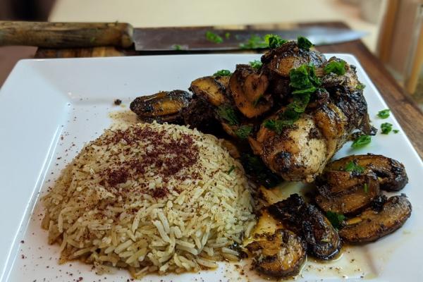 Lemon Herb Chicken with mushrooms and rice on white plate