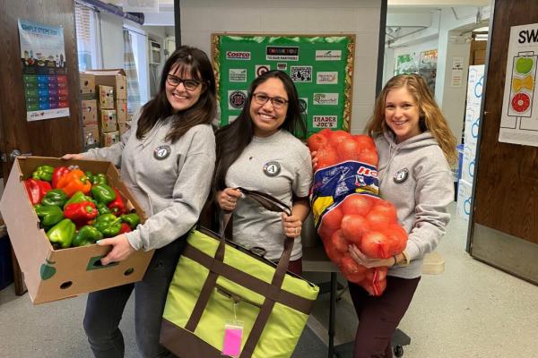 Volunteers holding boxes of food
