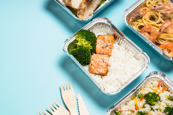 picture of various food dishes in foil packages with fork and knife