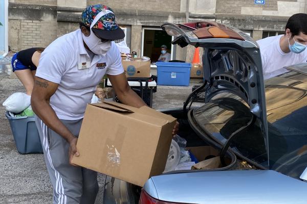 David loading box into trunk