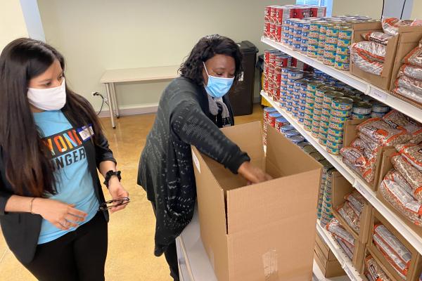 Alderman Emma Mitts packing a box for a Home Delivery Recipient