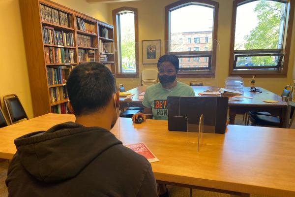 Beyond Hunger Social Services Coordinator sitting with person at the desk