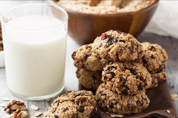 Oatmeal Raisin Cookie Baked Oatmeal Recipe Photo. Pile of cookies next to a glass of milk in a clear glass.