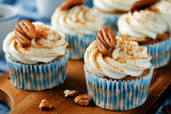 Hummingbird Cupcakes with cream cheese frosting - light dusting of cinnamon and pecan halves