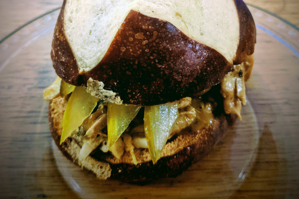 Pulled pork sandwich on a pretzel bun