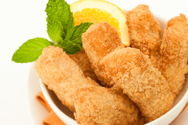 crispy catfish nuggets in a bowl with lemon wedge