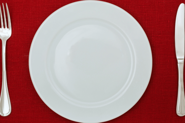 Plate on Red Tablecloth with fork and knife