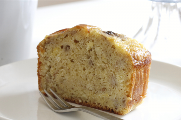 Thick slice of Yogurt Banana Bread on a white plate, against a white background.