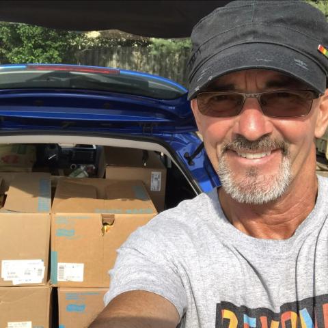 Bob standing next to a trunk full of food ready to be delivered to the pantry